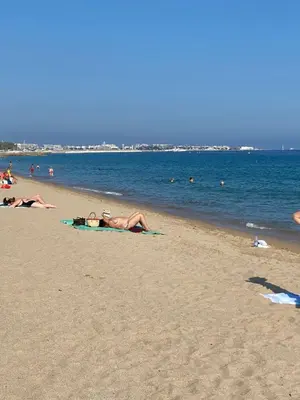 a group of people laying on the beach at Chambre spacieuse indépendante dans villa plus parking privée in Le Cannet