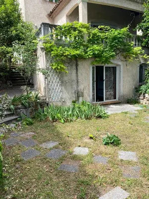 a house with a yard with rocks and plants at Chambre spacieuse indépendante dans villa plus parking privée in Le Cannet
