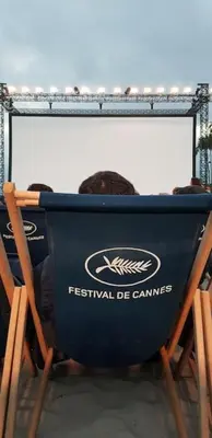 a person sitting in a chair in front of a mirror at Superbe 2 pièces au calme absolu in Cannes