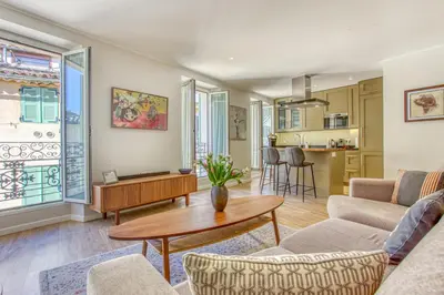 a living room with a table and chairs at Style in Cannes-Beautiful Apt-5 mins stroll to Festival-Beach-Port in Cannes