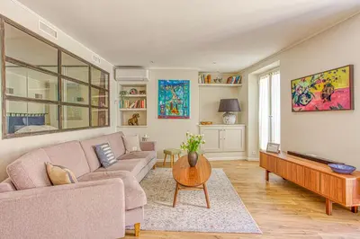 a living room with a couch and a tv at Style in Cannes-Beautiful Apt-5 mins stroll to Festival-Beach-Port in Cannes