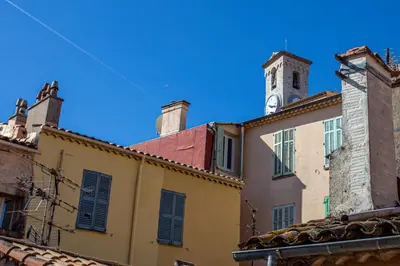 a building with a clock tower on top of it at Style in Cannes-Beautiful Apt-5 mins stroll to Festival-Beach-Port in Cannes