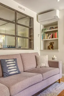a couch in a living room with a window at Style in Cannes-Beautiful Apt-5 mins stroll to Festival-Beach-Port in Cannes