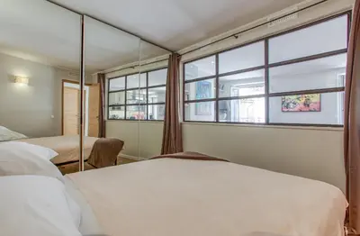 a bedroom with two beds and a window at Style in Cannes-Beautiful Apt-5 mins stroll to Festival-Beach-Port in Cannes