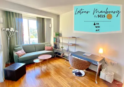 a living room with a couch and a table at Latour Maubourg By SCLS Locations in Cannes
