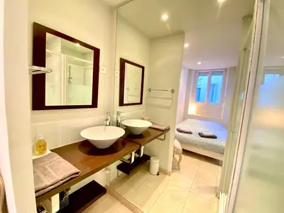 a bathroom with two sinks and a shower at Latour Maubourg By SCLS Locations in Cannes