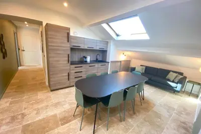 a kitchen and dining room with a table and a couch at Brand new 4 bedrooms 4 bathrooms Heart of Cannes in Cannes