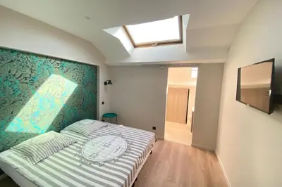 a bedroom with a bed with a painting on the wall at Brand new 4 bedrooms 4 bathrooms Heart of Cannes in Cannes