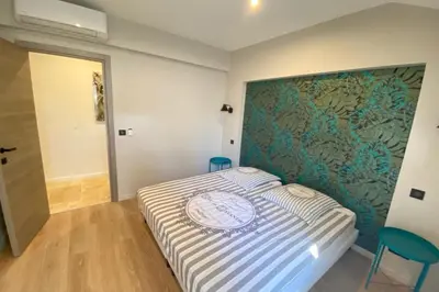 a bedroom with a bed with a large headboard at Brand new 4 bedrooms 4 bathrooms Heart of Cannes in Cannes