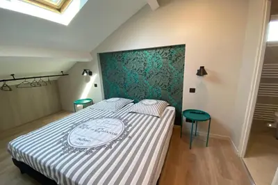 a bedroom with a bed with a blue and white bedspread at Brand new 4 bedrooms 4 bathrooms Heart of Cannes in Cannes