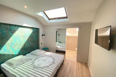 a bedroom with a bed and a skylight at Brand new 4 bedrooms 4 bathrooms Heart of Cannes in Cannes