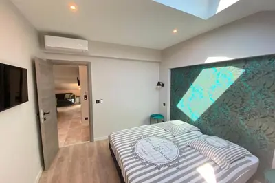 a bedroom with a bed with a large poster on the wall at Brand new 4 bedrooms 4 bathrooms Heart of Cannes in Cannes
