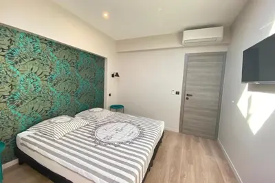 a bedroom with a bed and a wall mural at Brand new 4 bedrooms 4 bathrooms Heart of Cannes in Cannes