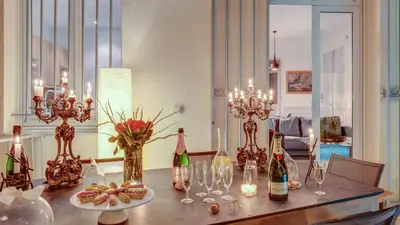 a dining room table with wine bottles and glasses at Cocoon in Cannes ***** in Cannes