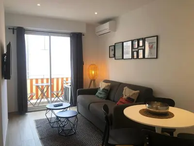 a living room with a couch and a table at C001-Beau studio neuf situé au centre in Cannes
