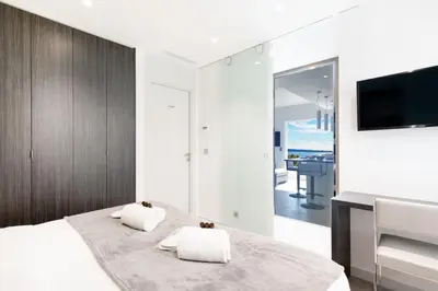 a bedroom with a bed with two pillows on it at Blue Dreams YourHostHelper in Cannes