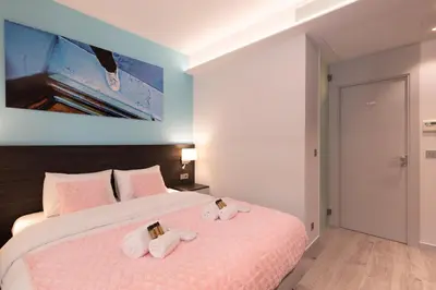 a bedroom with a bed with two towels on it at Blue Dreams YourHostHelper in Cannes