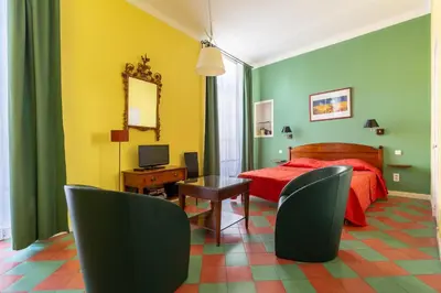 a red bedroom with a red bed and a chair at Cannes-Hyper-Centre in Cannes