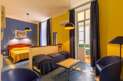 a bedroom with a bed and a desk and a window at Cannes-Hyper-Centre in Cannes
