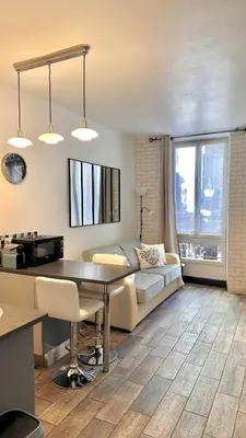 a living room with a couch and a table at Monroe's studio at the heart of Cannes and beaches in Cannes