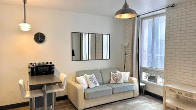a living room with a couch and a table at Monroe's studio at the heart of Cannes and beaches in Cannes