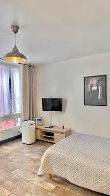 a bedroom with a bed and a flat screen tv at Monroe's studio at the heart of Cannes and beaches in Cannes
