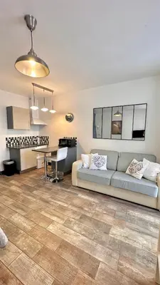a living room with a couch and a table at Monroe's studio at the heart of Cannes and beaches in Cannes