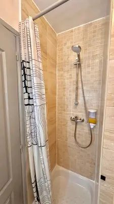 a shower with a shower curtain in a bathroom at Monroe's studio at the heart of Cannes and beaches in Cannes