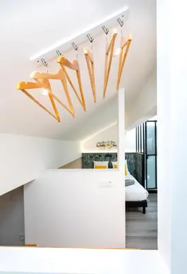 a room with white walls and a ceiling with a chandelier at Duplex : Plage 300m, Clim, Netflix in Cannes