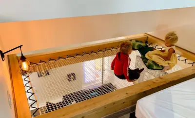 a group of people sitting in a bird cage at Duplex : Plage 300m, Clim, Netflix in Cannes
