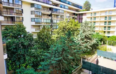 a kitchen with a counter with two chairs and a table at Studio Cannes center next to Croisette and rue d'Antibes in Cannes