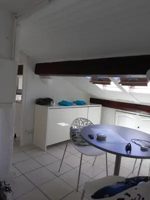a kitchen with a table and chairs in a room at Gatsby Cannes Croisette in Cannes