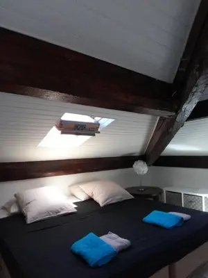 a bedroom with a bed with two blue towels on it at Gatsby Cannes Croisette in Cannes