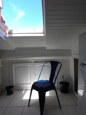 a blue chair sitting in a room with a window at Gatsby Cannes Croisette in Cannes