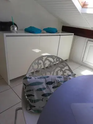 a chair sitting at a table in a kitchen at Gatsby Cannes Croisette in Cannes