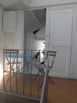 a table and chairs in a room with a door at Gatsby Cannes Croisette in Cannes