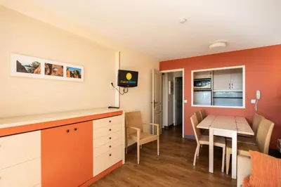 a small kitchen and dining room with a table at Résidence Cannes Villa Francia - maeva Home - Appartement 3 Pièces 6 Personnes - Confort MAE-6059 in Cannes