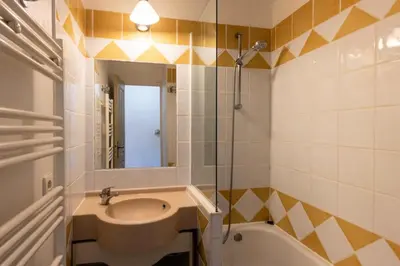 a bathroom with a sink and a tub and a mirror at Résidence Cannes Villa Francia - maeva Home - Appartement 3 Pièces 6 Personnes - Confort MAE-6059 in Cannes