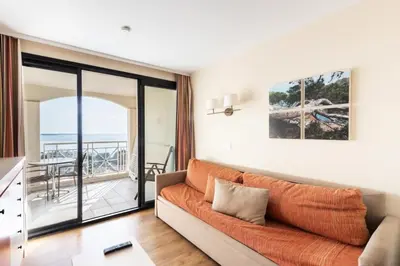 a living room with a couch and a balcony at Résidence Cannes Villa Francia - maeva Home - Appartement 2 Pièces 4 Personnes - Budget MAE-6120 in Cannes