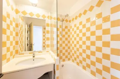 a bathroom with a tub and a sink and a mirror at Résidence Cannes Villa Francia - maeva Home - Appartement 2 Pièces 4 Personnes - Budget MAE-6120 in Cannes