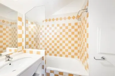 a bathroom with a tub and a sink and a shower at Résidence Cannes Villa Francia - maeva Home - Appartement 2 Pièces 6 Personnes - Budget MAE-6123 in Cannes