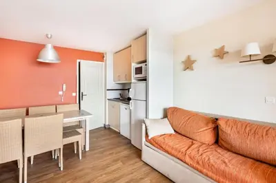 a living room with a couch and a kitchen at Résidence Cannes Villa Francia - maeva Home - Appartement 2 Pièces 6 Personnes - Budget MAE-6123 in Cannes