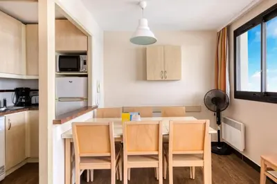 a kitchen and dining room with a table and chairs at Résidence Cannes Villa Francia - maeva Home - Appartement 2 Pièces 6 Personnes - Sélection MAE-6133 in Cannes