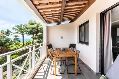 a dining room with a table and chairs on a balcony at Résidence Cannes Villa Francia - maeva Home - Appartement 2 pièces 6 personnes avec très belle vue mer - Prestige - super Home MAE-6260 in Cannes