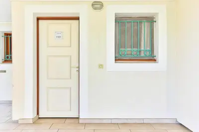 a white door with a window on a white wall at Résidence Cannes Villa Francia - maeva Home - Studio 4 personnes - Sélection MAE-6353 in Cannes