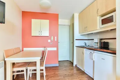 a kitchen with a table and chairs in a room at Résidence Cannes Villa Francia - maeva Home - Studio 4 personnes - Sélection MAE-6353 in Cannes