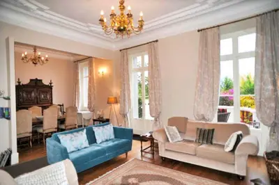 a living room with a blue couch and chairs at Ref ROSE - Palmes d'Or Properties in Cannes