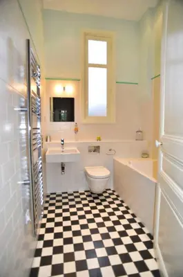 a bathroom with a black and white checkered floor at Ref ROSE - Palmes d'Or Properties in Cannes