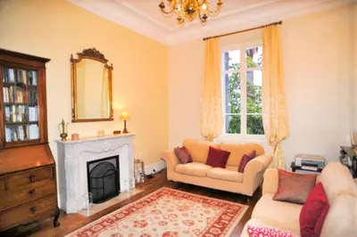 a living room with a couch and a fireplace at Ref ROSE - Palmes d'Or Properties in Cannes
