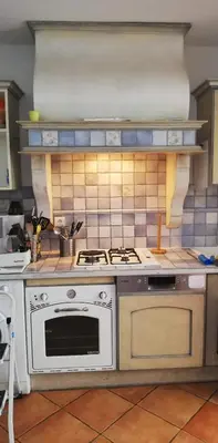 a kitchen with a stove and a white oven at Appartement de charme wi-fi ,clim, garage jardin privés, piscine environnement arboré in Cannes
